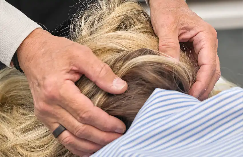 Close up shot of chiropractor applying a Occipital Fibre Analysis