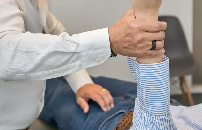 Chiropractor applying the Arm Fossa Test on patient